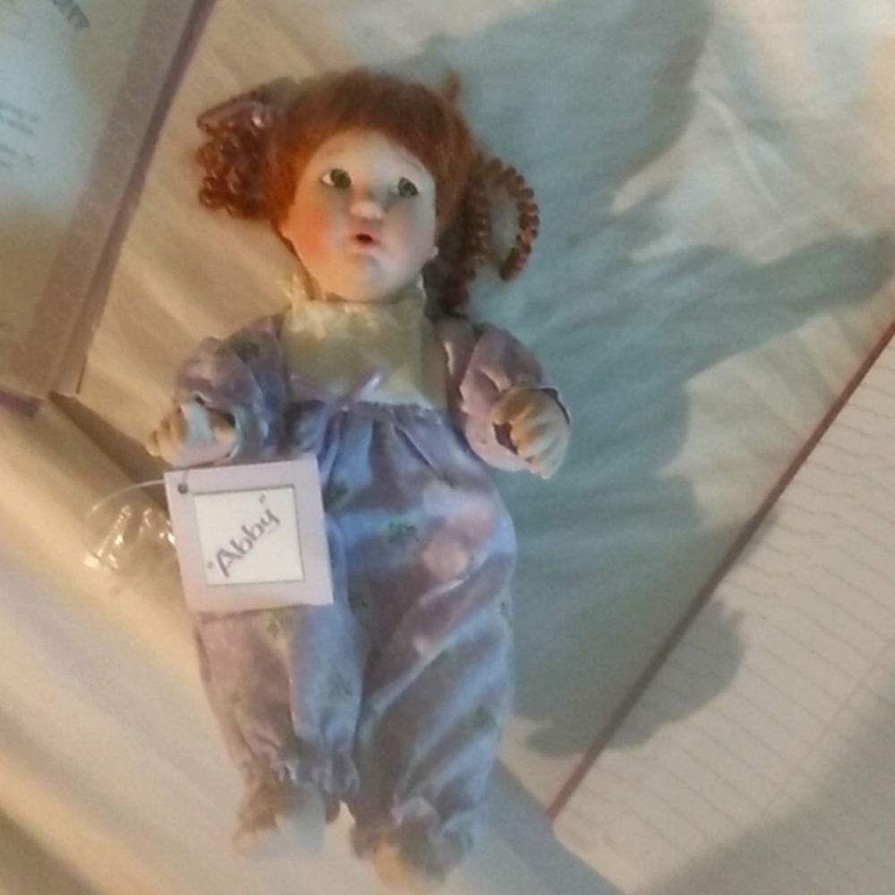 Porcelain baby girl doll.